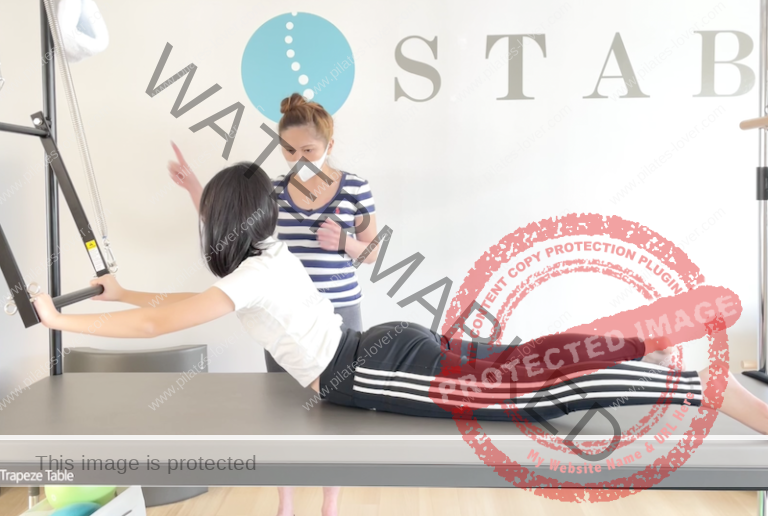 Cadillac swan dive pilates exercise in stottpilates